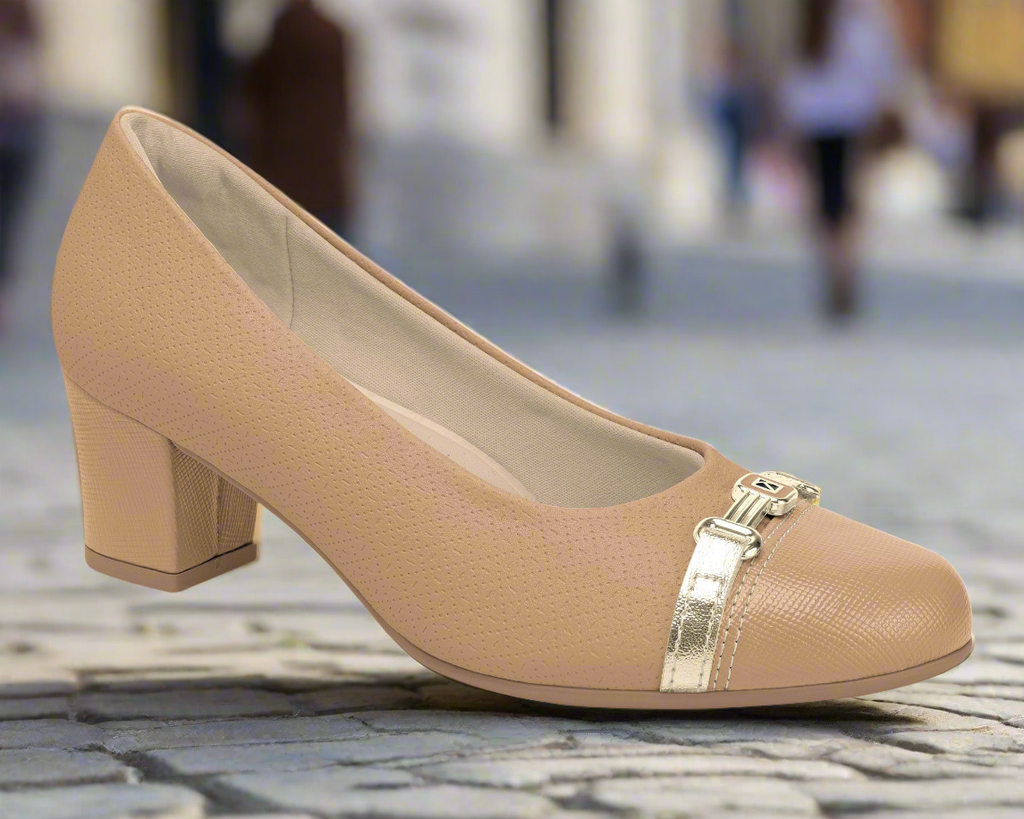 The Piccadilly Ref: 110173-003 Nude Claro business court shoe features a closed toe, medium heel, gold buckle detail, subtle textured pattern, and a cushioned insole—combining elegance and comfort for your professional wardrobe.